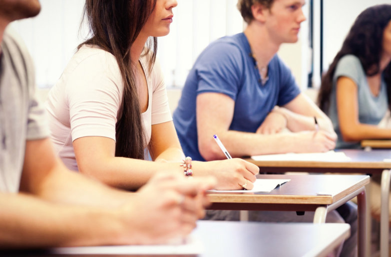 Studious young adults listening while sitting