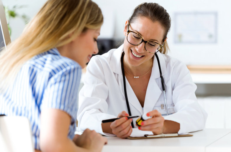 Portrait of female doctor prescribing medication for patient