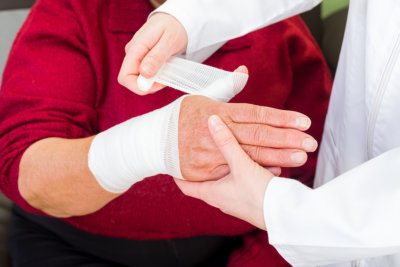 bandaging elderly woman